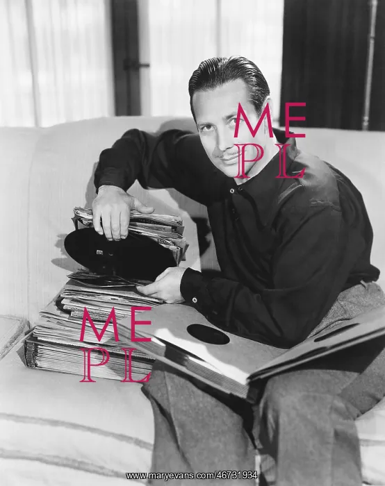 : Portrait of a man sitting on a couch and taking : Portrait of a man sitting on a couch and taking