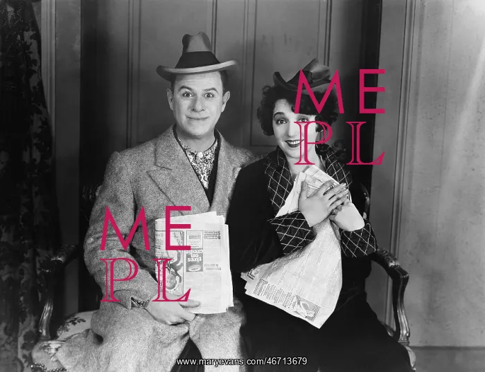 : Portrait of smiling couple with newspapers : Portrait of smiling couple with newspapers