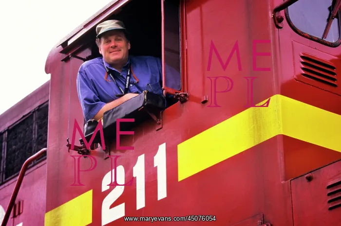 : Portrait of Train Engineer Leaning Out of Train Cab Window : Portrait of Train Engineer Leaning Out of Train Cab Window