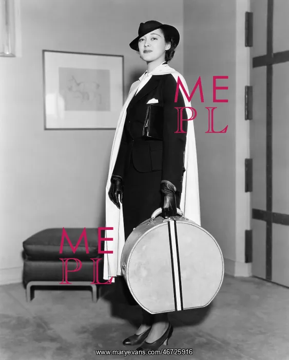 : Portrait of woman carrying hatbox : Portrait of woman carrying hatbox