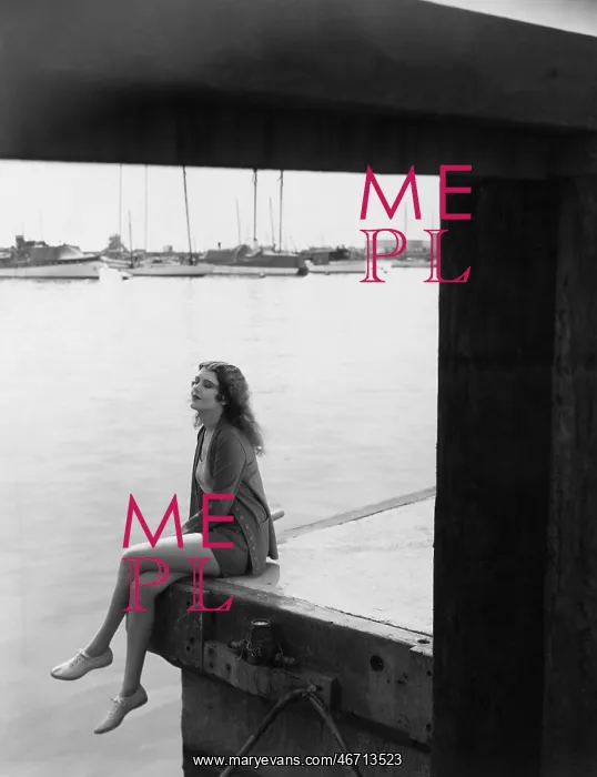  : Portrait of woman sitting on dock