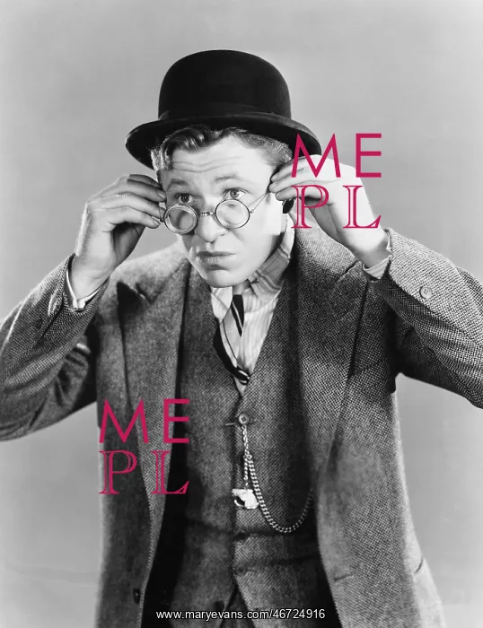  : Portrait of young man putting on glasses