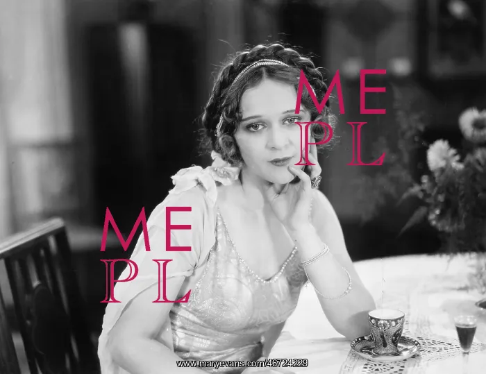 : Portrait of a young woman sitting at a table and : Portrait of a young woman sitting at a table and
