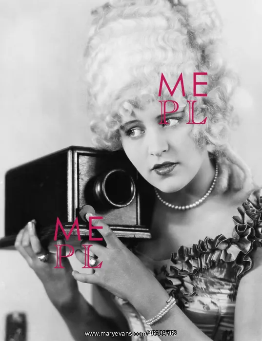 : Portrait of a young woman using a camera : Portrait of a young woman using a camera