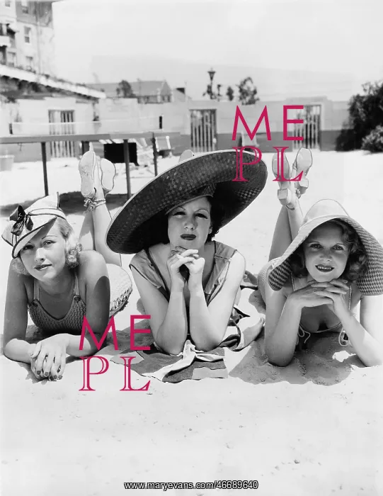 : Portrait of three young women lying on the beach : Portrait of three young women lying on the beach