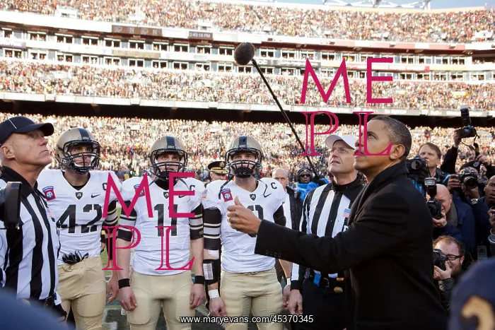 : President Barack Obama performs the coin toss before : President Barack Obama performs the coin toss before