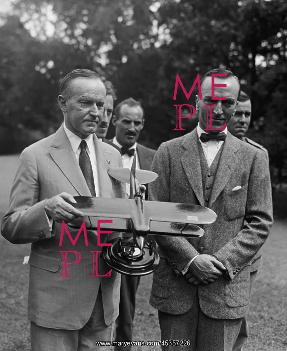 : President Calvin Coolidge examines a model airplane : President Calvin Coolidge examines a model airplane