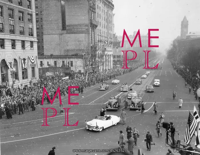 : President Eisenhower standing in an open car in : President Eisenhower standing in an open car in
