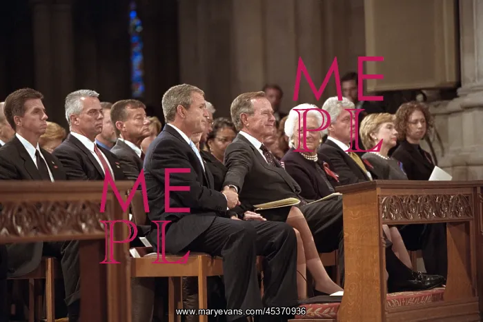  : President George W. Bush grasps the hand of his