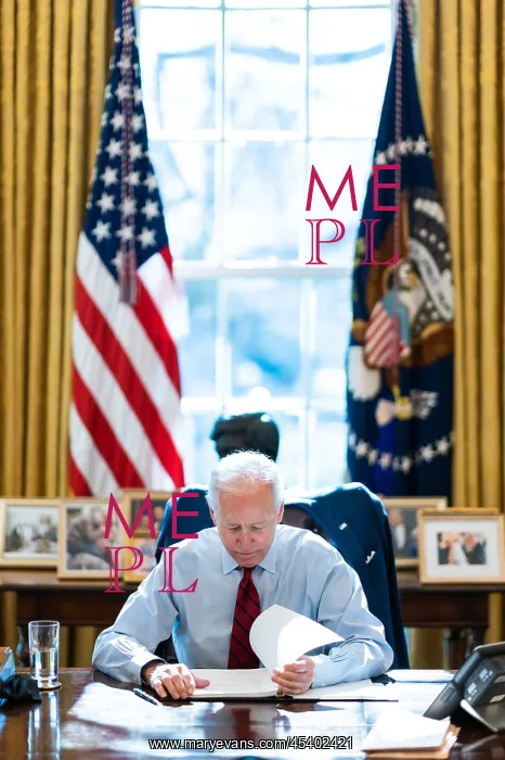 : President Joe Biden reading documents at his desk : President Joe Biden reading documents at his desk