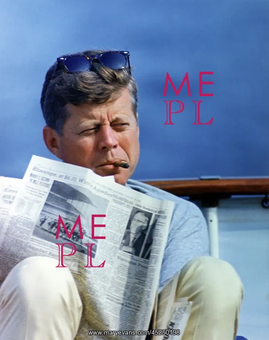  : President John Kennedy smoking a cigar while reading