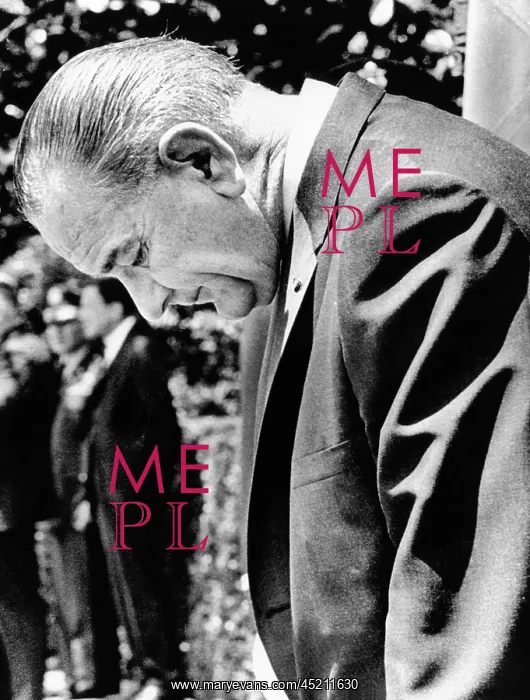 : President Lyndon Johnson stands with head ? : President Lyndon Johnson stands with head ?
