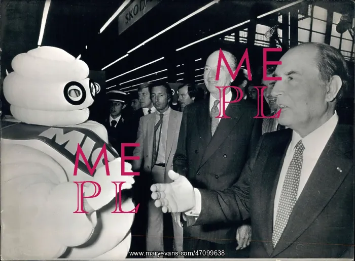 : President Mitterrand with Michelin Man at a car show : President Mitterrand with Michelin Man at a car show