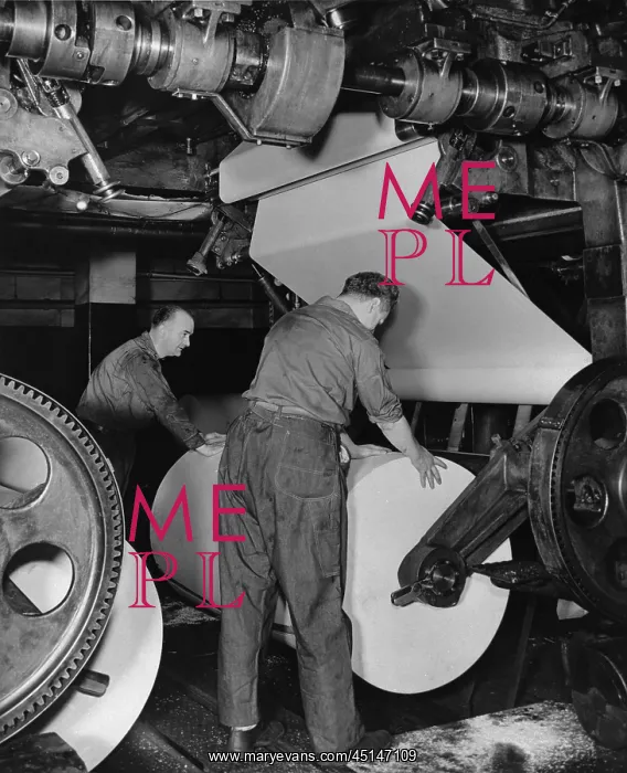 : Pressman Loading Roll of Paper on Newspaper Press : Pressman Loading Roll of Paper on Newspaper Press