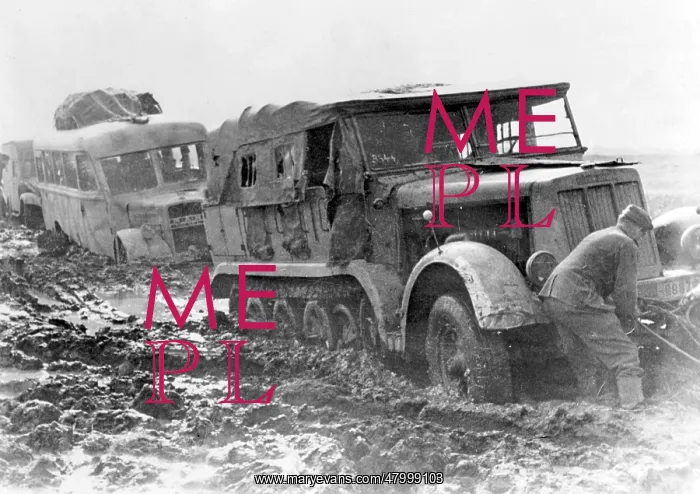 : A prime mover, towing a bus, is stranded in the mud : A prime mover, towing a bus, is stranded in the mud