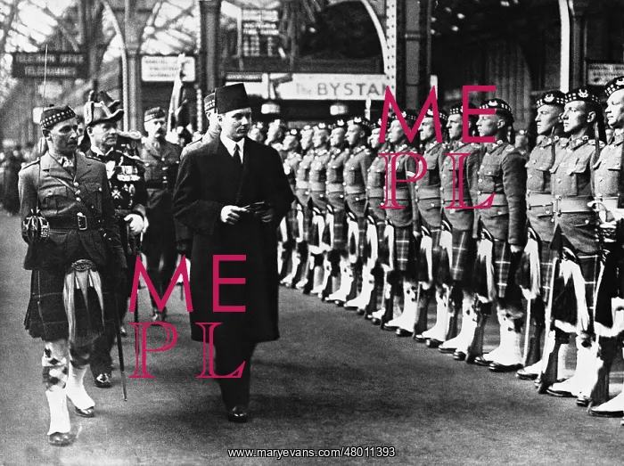: Prince Faruk strides before the front of a British Guard of : Prince Faruk strides before the front of a British Guard of
