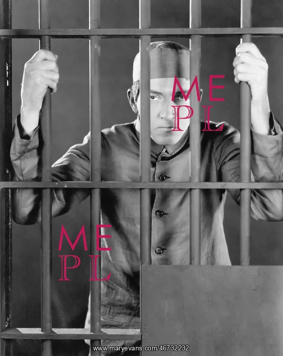  : Prisoner behind bars looking angry and sad