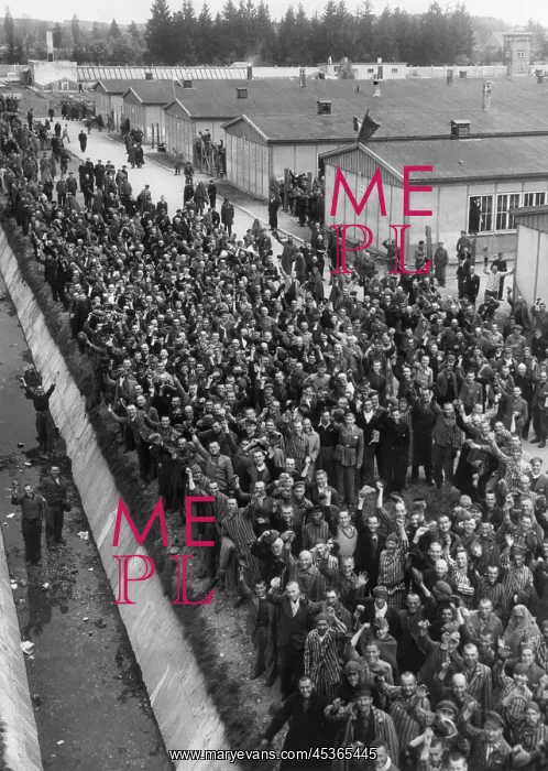 : Prisoners at Dachau shout a greeting to liberating : Prisoners at Dachau shout a greeting to liberating