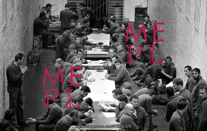 : Prisoners sitting at long tables in courtyard : Prisoners sitting at long tables in courtyard