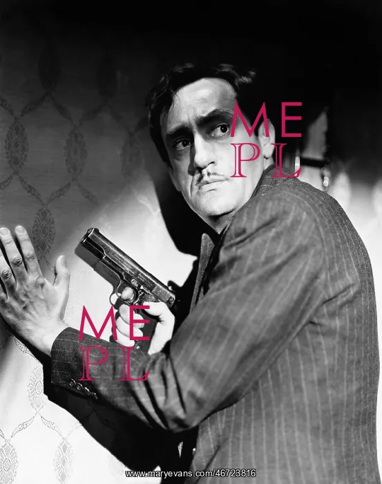 : Profile of a gangster holding a handgun looking : Profile of a gangster holding a handgun looking