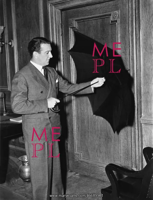 : Profile of a man opening an umbrella : Profile of a man opening an umbrella