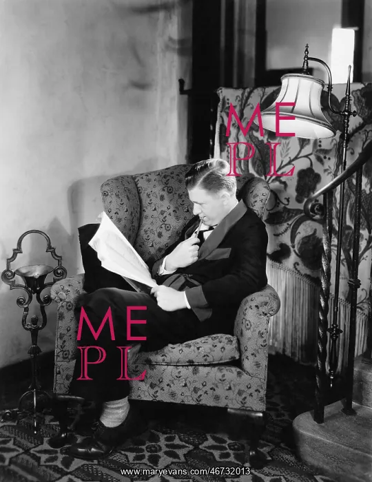 : Profile of a man sitting in an armchair and reading a book : Profile of a man sitting in an armchair and reading a book