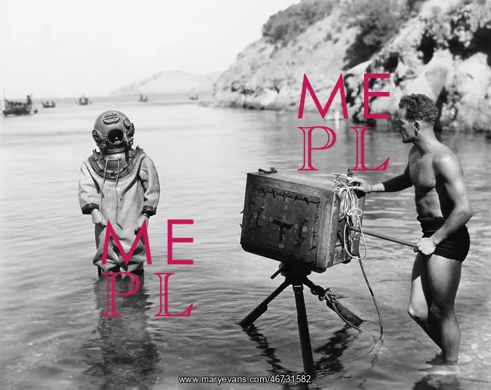 : Profile of a young man holding a camera with a scuba : Profile of a young man holding a camera with a scuba