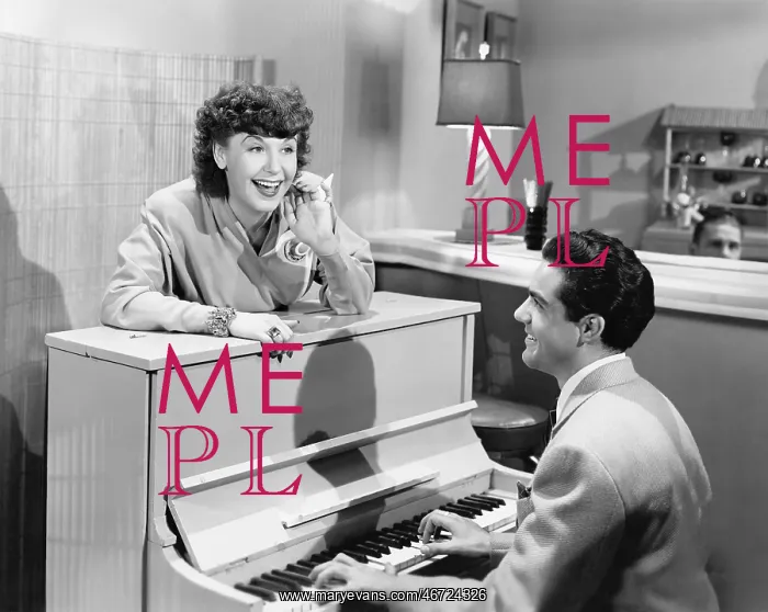 : Profile of a young man playing a piano with a young : Profile of a young man playing a piano with a young