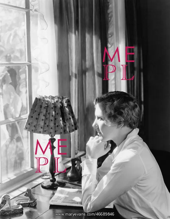 : Profile of a young woman sitting at a desk and looking : Profile of a young woman sitting at a desk and looking