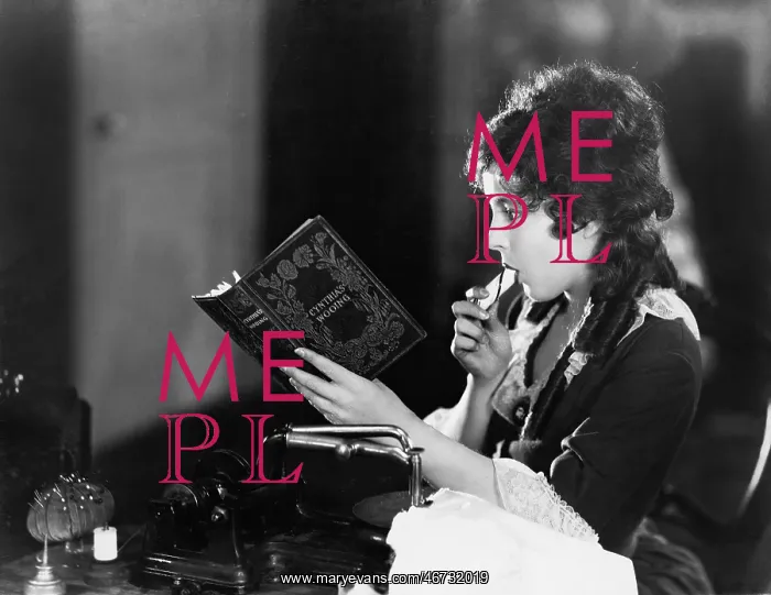 : Profile of a young woman sitting and reading a book : Profile of a young woman sitting and reading a book