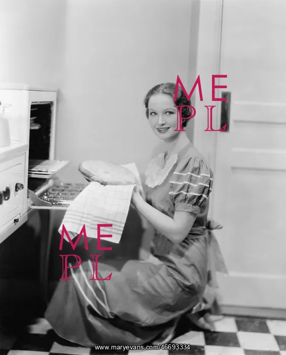 : Profile of a young woman taking a pie out of the : Profile of a young woman taking a pie out of the