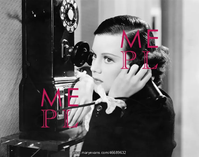 : Profile of a young woman talking on a payphone : Profile of a young woman talking on a payphone