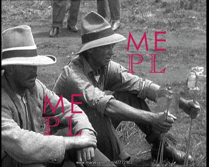 : Two Prospectors Sitting in a Field Holding : Two Prospectors Sitting in a Field Holding
