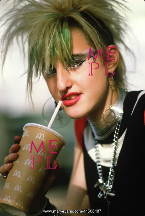 : Punk haired girl drinking branded drink : Punk haired girl drinking branded drink