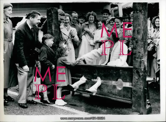 : Queen of the Fair at Cheam in ancient stocks : Queen of the Fair at Cheam in ancient stocks
