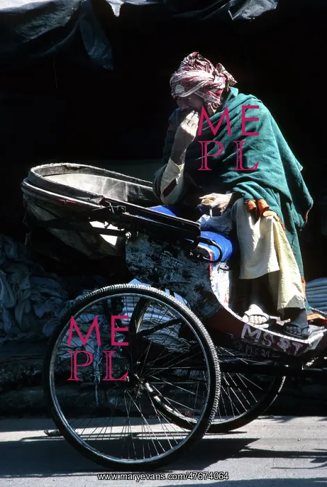 : A ragged driver sits on his cycle rickshaw, India : A ragged driver sits on his cycle rickshaw, India