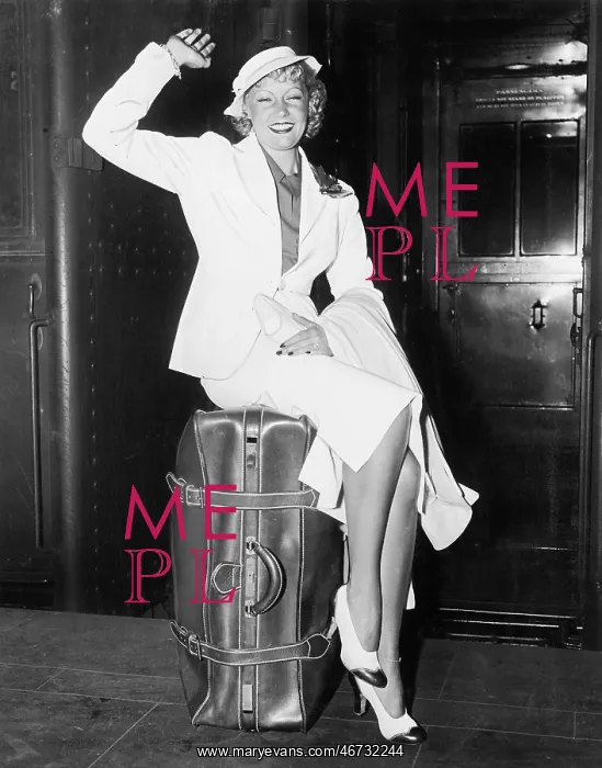 : A ready to go young woman sitting on her suitcase : A ready to go young woman sitting on her suitcase