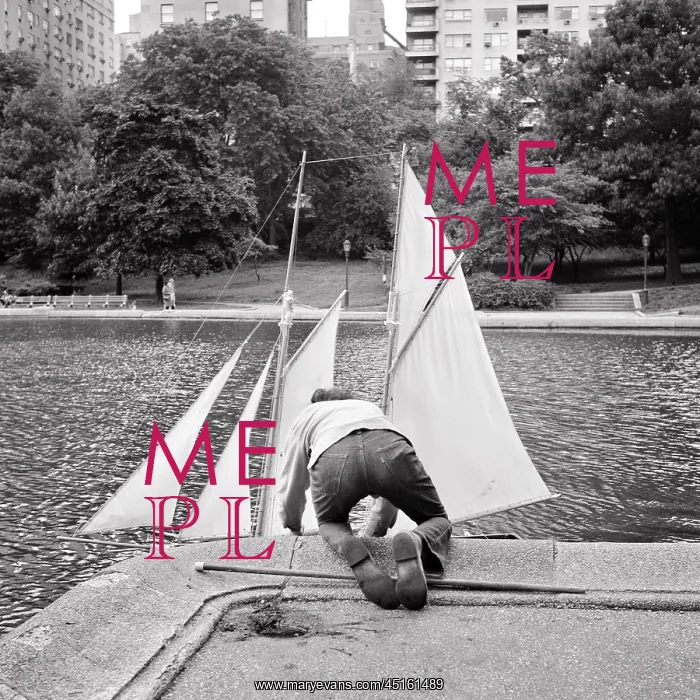 : Rear View Anonymous Boy Putting Toy Sailboat Into : Rear View Anonymous Boy Putting Toy Sailboat Into