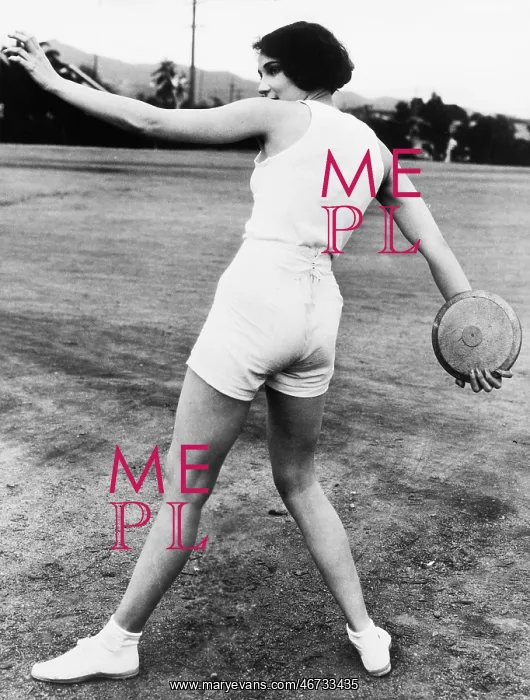 : Rear view of a young woman throwing a discus : Rear view of a young woman throwing a discus