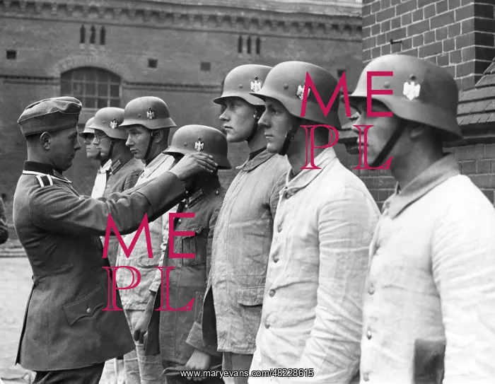 : Recruits get steel helmets in the barracks yard, 1937 : Recruits get steel helmets in the barracks yard, 1937