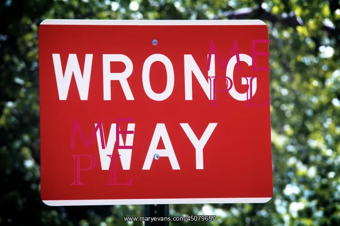  : Red and White Sign Boldly Stating Direction As Wrong Way