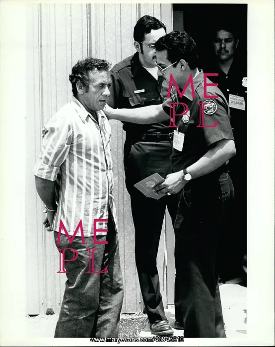 : Refugees. Feb. 25 Imagration officials talk to a handcuffed Cuban refugees : Refugees. Feb. 25 Imagration officials talk to a handcuffed Cuban refugees