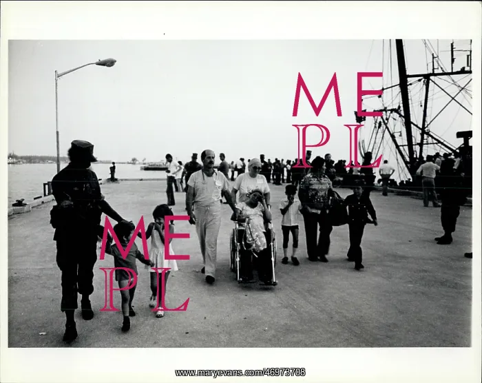 : Refugees. A marine leads a couples of giggling childred and weary adults away : Refugees. A marine leads a couples of giggling childred and weary adults away