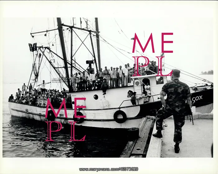 : Refugees. A marine waits at the dockside in Key West for a boat loaded : Refugees. A marine waits at the dockside in Key West for a boat loaded