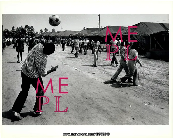: Refugees. Cuban Refugee pass the time by playing soccer in the tent city : Refugees. Cuban Refugee pass the time by playing soccer in the tent city