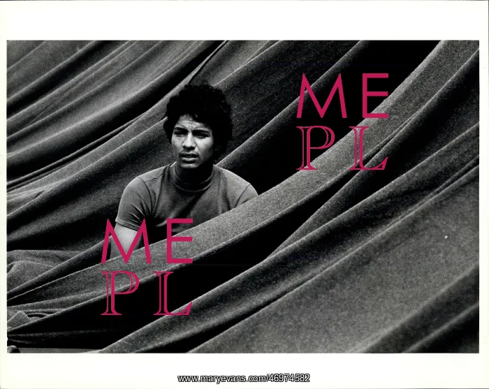 : Refugees. A Cuban refugee sits in his cot while being enclosed by blankets : Refugees. A Cuban refugee sits in his cot while being enclosed by blankets