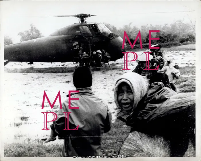 : Refugees. Feb. 21, 1967 - Vietnamese Families load aboard a Marine Helicopter to be lifted : Refugees. Feb. 21, 1967 - Vietnamese Families load aboard a Marine Helicopter to be lifted