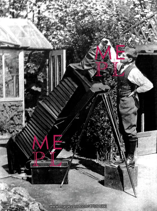 : Reginald Malby with a giant camera in his garden : Reginald Malby with a giant camera in his garden