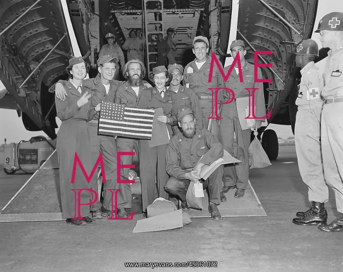 : Released POWs, a B-29 crew pose with their flight : Released POWs, a B-29 crew pose with their flight