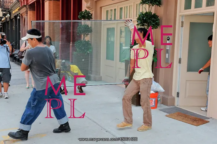 : Repairmen remove damaged glass wall : Repairmen remove damaged glass wall